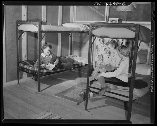 Interlochen, Michigan. National music camp where 300 or more young musicians study symphonic music for eight weeks each summer. Girls relaxing in their double deck bunks after supper