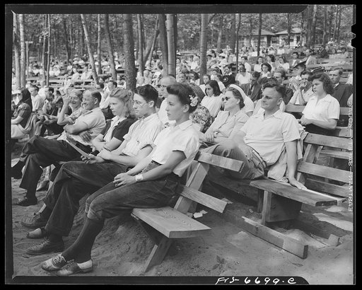 Interlochen, Michigan. National music camp where 300 or more young musicians study symphonic music for eight weeks each summer. Part of the crowd listening to symphonic music