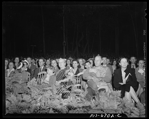 Interlochen, Michigan. National music camp where 300 or more young musicians study symphonic music for eight weeks each summer. Part of the crowd at a night performance of the symphony orchestra