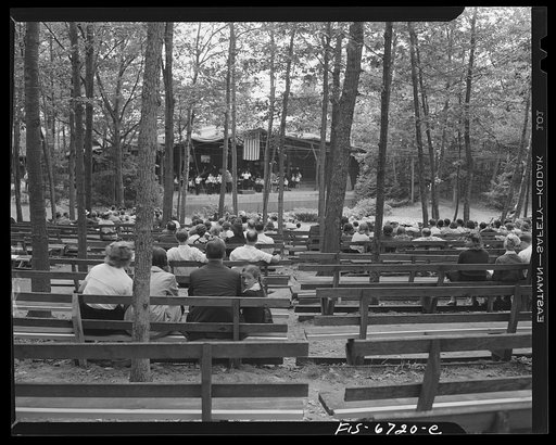 Interlochen, Michigan. National music camp where 300 or more young musicians study symphonic music for eight weeks each summer. Looking through the trees at orchestra practicing