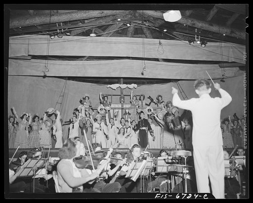 Interlochen, Michigan. National music camp where 300 or more young musicians study symphonic music for eight weeks each summer. Night performance of "Pirates of Penzance" [i.e., H.M.S. Pinafore] by Gilbert and Sullivan