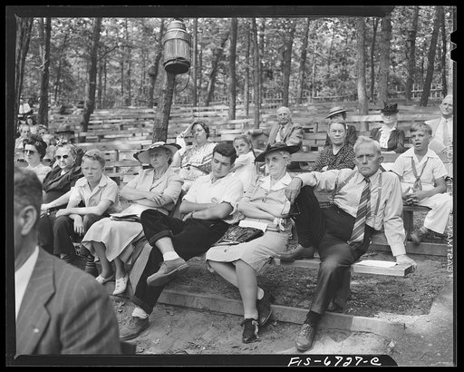 Interlochen, Michigan. National music camp where 300 or more young musicians study symphonic music for eight weeks each summer. Spectators watching a rehearsal