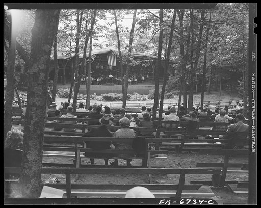 Untitled photo, possibly related to: Interlochen, Michigan. National music camp where 300 or more young musicians study symphonic music for eight weeks each summer. Looking through the trees at orchestra practicing