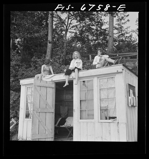 Interlochen, Michigan. National music camp where 300 or more young musicians study symphonic music for eight weeks each summer. Girls swimming during the recreation period. Girls sunning themselves after a swim
