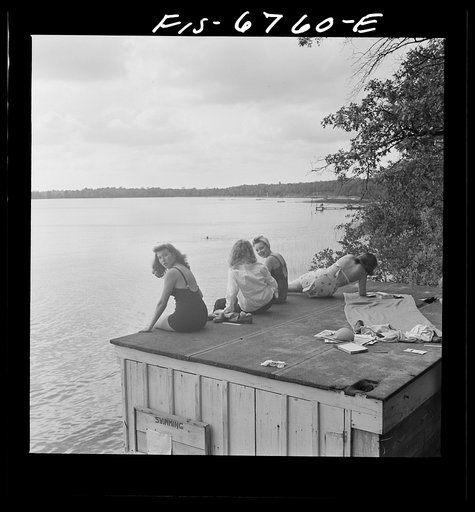 Untitled photo, possibly related to: Interlochen, Michigan. National music camp where 300 or more young musicians study symphonic music for eight weeks each summer. Long shot showing swimming and the diving raft