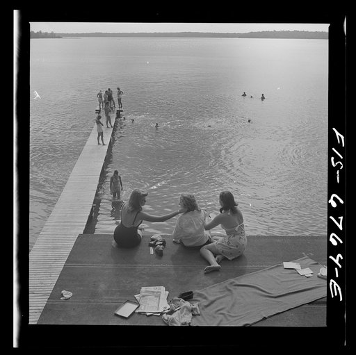 Interlochen, Michigan. National music camp where 300 or more young musicians study symphonic music for eight weeks each summer. Long shot showing swimming and the diving raft