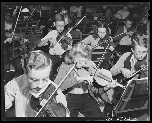 Interlochen, Michigan. National music camp where 300 or more young musicians study symphonic music for eight weeks each summer. Violin section of symphony orchestra