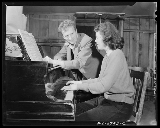 Interlochen, Michigan. National music camp where 300 or more young musicians study symphonic music for eight weeks each summer. Percy Grainger, famous pianist and composer, with a student