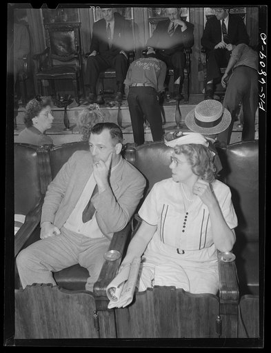 Untitled photo, possibly related to: New York, New York. Shoeshine parlor on East Forty-Second Street. Customers in the foreground are waiting while their shoes are repaired
