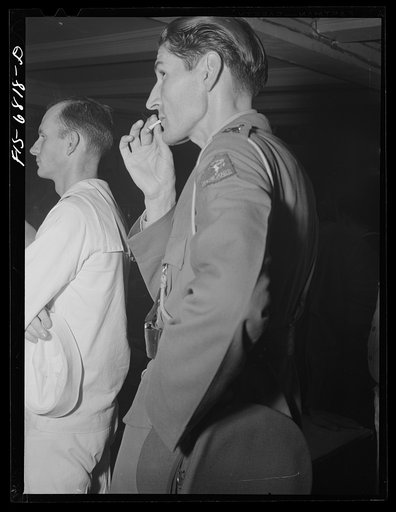 New York, New York. Dutch officer and American sailor in the audience at the Stage Door canteen