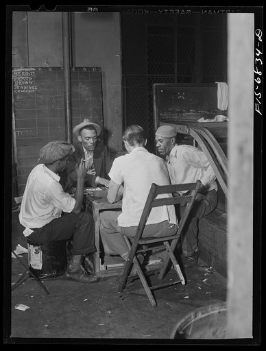 New York, New York. Boys who pick up pins and roll back balls in a Broadway bowling alley playing cards between shifts