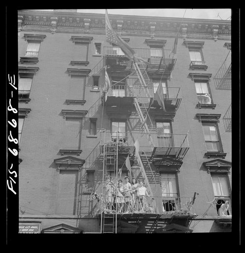 Untitled photo, possibly related to: New York, New York. Italian-American watching parade on Mott Street and flag raising ceremony in honor of boys from the neighborhood in the United States Army