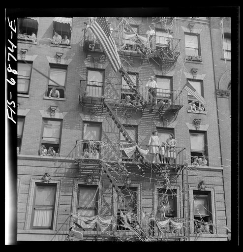 New York, New York. Italian-American watching parade on Mott Street and flag raising ceremony in honor of boys from the neighborhood in the United States Army