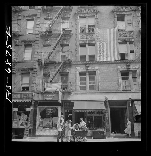 Untitled negative showing Italian Americans on Thompson Street relaxing on Sunday