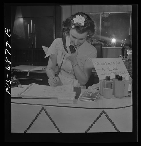 New York, New York. Receptionist making an appointment at Francois de Paris, a hairdresser on Eighth Street