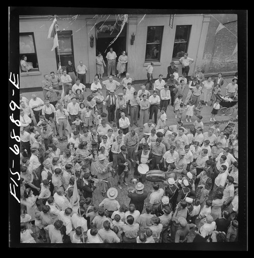 New York, New York. Dancing and music on Mott Street, at a flag raising ceremony in honor of neighborhood boys in the United States Army