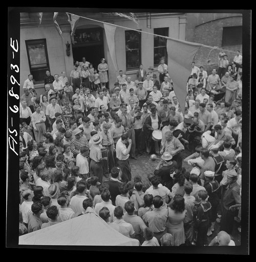 Untitled photo, possibly related to: New York, New York. Dancing and music on Mott Street, at a flag raising ceremony in honor of neighborhood boys in the United States Army