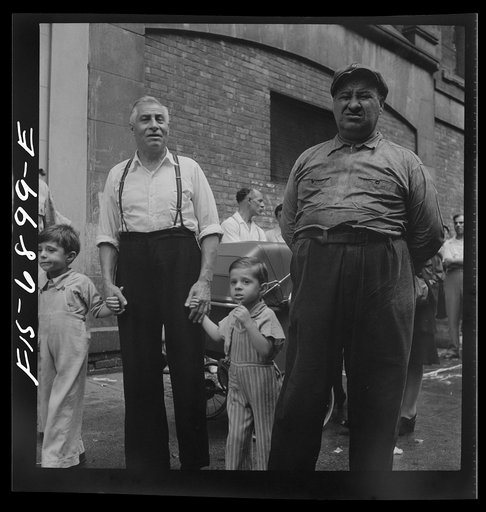 Untitled photo, possibly related to: New York, New York. Italian-Americans in the rain watching a flag raising ceremony in honor of the feast of San Rocco at right