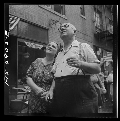 New York, New York. Italian-Americans in the rain watching a flag raising ceremony in honor of the feast of San Rocco at right