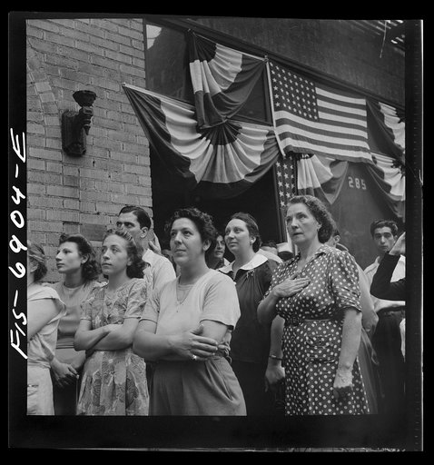 New York, New York. Italian-Americans in the rain watching a flag raising ceremony in honor of the feast of San Rocco at right