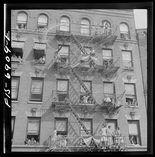 Untitled photo, possibly related to: New York, New York. Italian-Americans in the rain watching a flag raising ceremony in honor of the feast of San Rocco at right