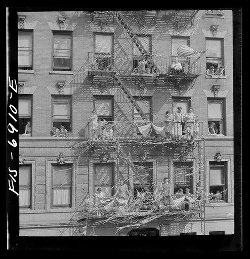 New York, New York. Italian-Americans in the rain watching a flag raising ceremony in honor of the feast of San Rocco at right