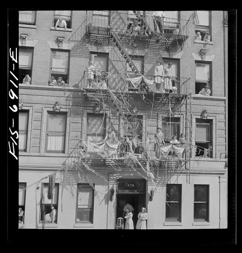 Untitled photo, possibly related to: New York, New York. Italian-Americans in the rain watching a flag raising ceremony in honor of the feast of San Rocco at right