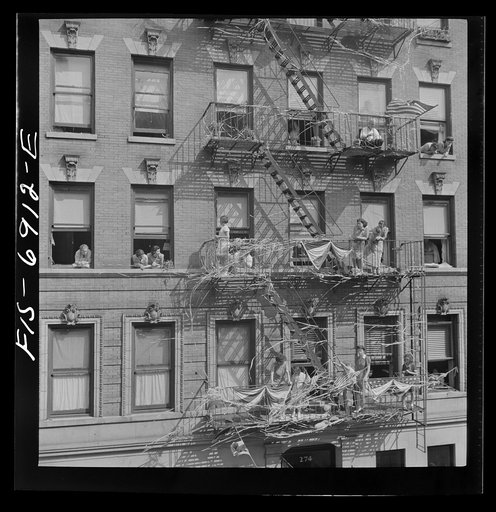 Untitled photo, possibly related to: New York, New York. Italian-Americans in the rain watching a flag raising ceremony in honor of the feast of San Rocco at right