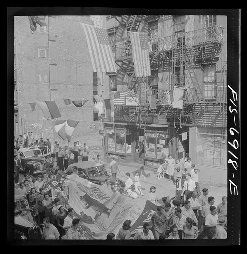 Untitled photo, possibly related to: New York, New York. Italian-Americans of Mott Street raising a flag in honor of neighborhood boys in the United States Army
