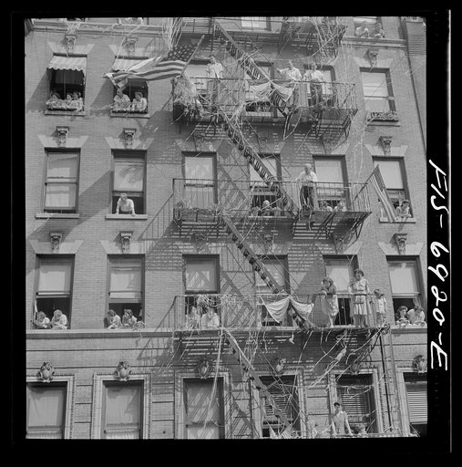 New York, New York. Italian-Americans in the rain watching a flag raising ceremony in honor of neighborhood boys in the United States Army