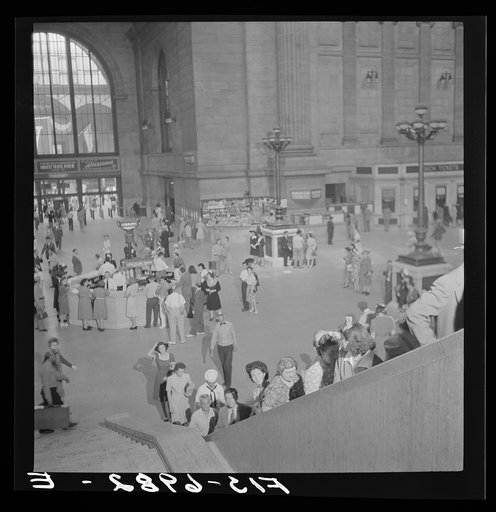 Untitled photo, possibly related to: New York, New York. Information booth and escalators at the Pennsylvania railroad station