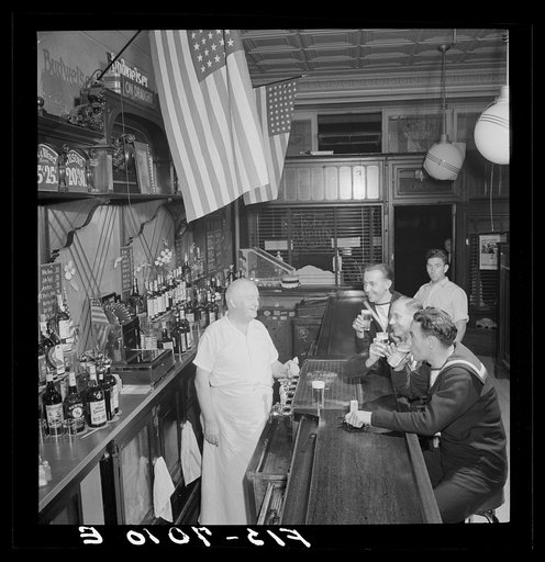 Untitled photo, possibly related to: New York, New York. Irish-American bartender serving beer to British sailors in a Third Avenue bar in the "Forties"