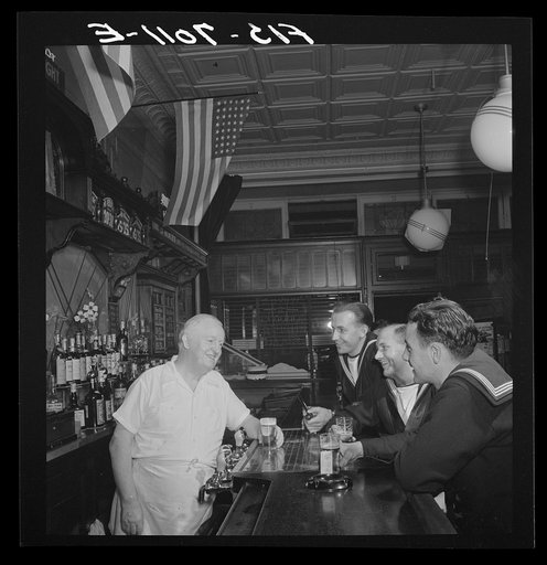 New York, New York. Irish-American bartender serving beer to British sailors in a Third Avenue bar in the "Forties"