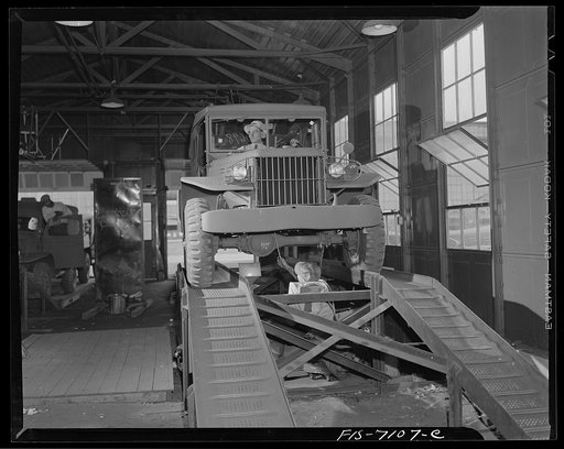 Chrysler Corporation. Dodge truck plant. Detroit, Michigan (vicinity). War worker checking lubrication as another Dodge army truck nears delivery to the Army
