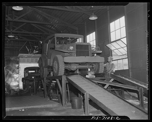 Chrysler Corporation. Dodge truck plant. Detroit, Michigan (vicinity). Lubrication, springs, axles, and the entire undercarriage of this Dodge Army truck is given a final inspection by workmen