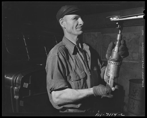 Untitled photo, possibly related to: Detroit, Michigan (vicinity). Chrysler Corporation Dodge truck plant. Workers tighten body and frame bolts quickly and uniformly with modern, automatic wrenches