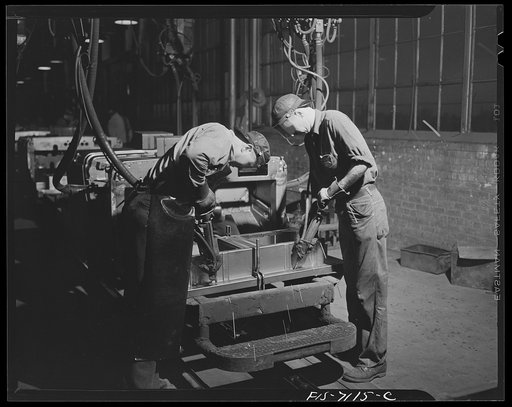 Chrysler Corporation. Dodge truck plant. Detroit, Michigan (vicinity). Spot-welding has supplanted bolts and rivets in many operations in the building of Dodge Army trucks. Here, two workers speed another Army vehicle along the production line