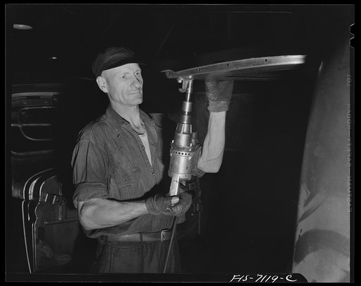 Detroit, Michigan (vicinity). Chrysler Corportation Dodge truck plant. Workers tighten body and frame bolts quickly and uniformly with modern, automatic wrenches