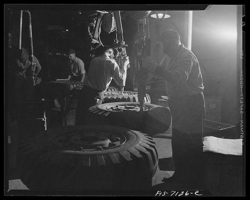 Untitled photo, possibly related to: Detroit, Michigan (vicinity). Chrysler corporation Dodge truck plant. These tires are for Dodge Army trucks. Overhead conveyors quickly move them from receiving docks to their proper places along the vast production line