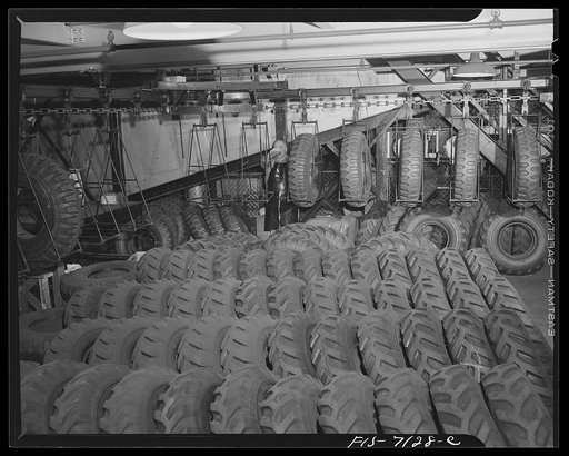 Detroit, Michigan (vicinity). Chrysler Corporation Dodge truck plant. Row upon row of rugged tires wait to be lifted on to conveyors which deposit them at the right spot on the steadily moving Dodge Army truck production line