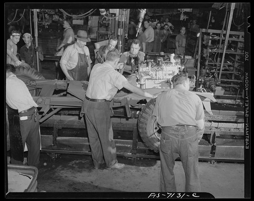 Detroit, Michigan (vicinity). Chrysler Corporation Dodge truck plant. Lowering an engine to the chassis of a Dodge Army truck. Vehicles for the armed forces move in a steady stream along this busy production line