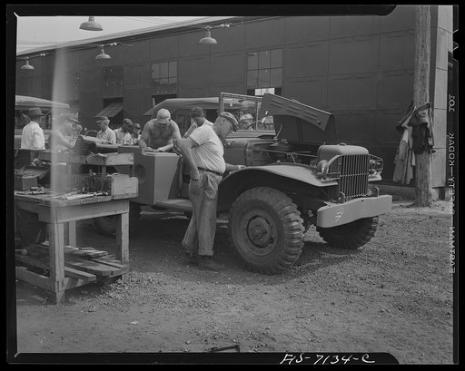 Untitled photo, possibly related to: Detroit, Michigan (vicinity). Chrysler Corporation Dodge truck plant. A sharp-eyed inspector checks engine accessories of a Dodge Army truck which is ready for shipment