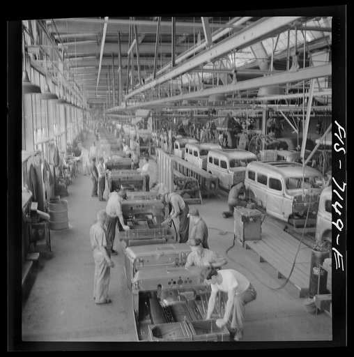 Untitled photo, possibly related to: Detroit, Michigan (vicinity). Chrysler Corporation Dodge truck plant. A steady stream of bodies for Dodge Army trucks receive important finishing operations along this section of the production line