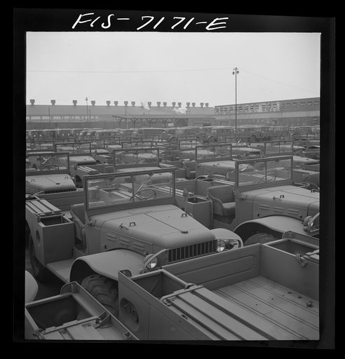 Untitled photo, possibly related to: Detroit, Michigan (vicinity). Chrysler Corporation Dodge truck plant. Side by side and end to end of Dodge Army trucks, produced daily, stand in the yards waiting for the final touches that make them effective fighting vehicles