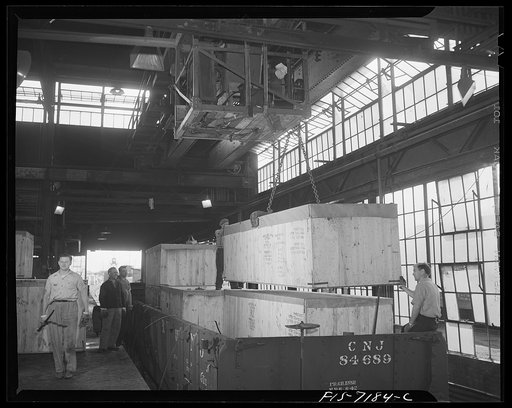 Detroit, Michigan (vicinity). Chrysler Corporation Dodge truck plant. Dodge truck, securely crated, being loaded on a freight car for export