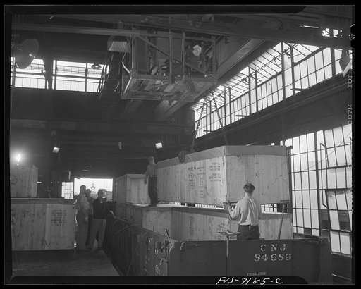 Detroit, Michigan (vicinity). Chrysler Corporation Dodge truck plant. Truck securely crated being loaded on a freight car for export