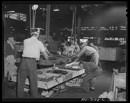 Dodge truck plant, Detroit, Michigan. Beginning of packing of crate, showing chassis being lowered onto crate bottom