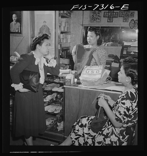 Untitled photo, possibly related to: New York, New York. Lily Chi, owner of a Chinese gift shop in Chinatown, mending a paper dragon
