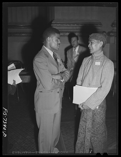Washington, D.C. International youth assembly. American student from North Carolina College at Durham, left, and a delegate from Dutch East Indies