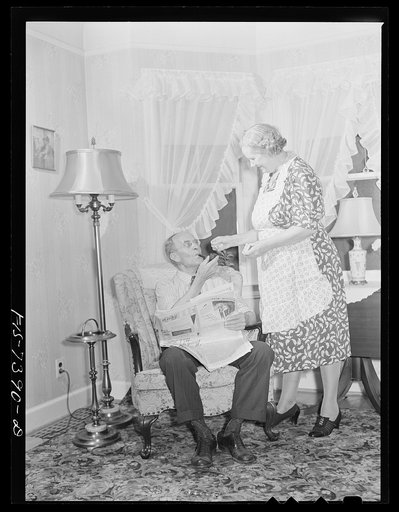 Cass Lake, near Pontiac, Michigan. Mrs. Westerberg lighting a match for her husband's pipe as he relaxes after a day at the Johansson gauge division of the Ford Motor Company where he is foreman of the rough stock department